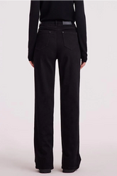 the back view of a lady in black straight leg jeans